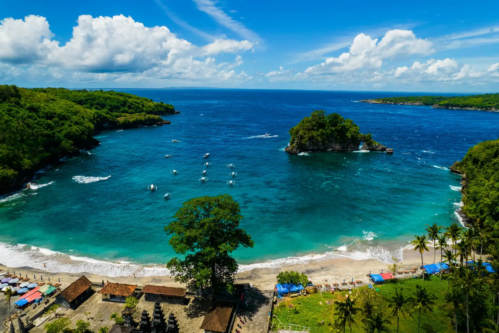 Boats anchored in a turquoise bay off Nusa Penida, Bali